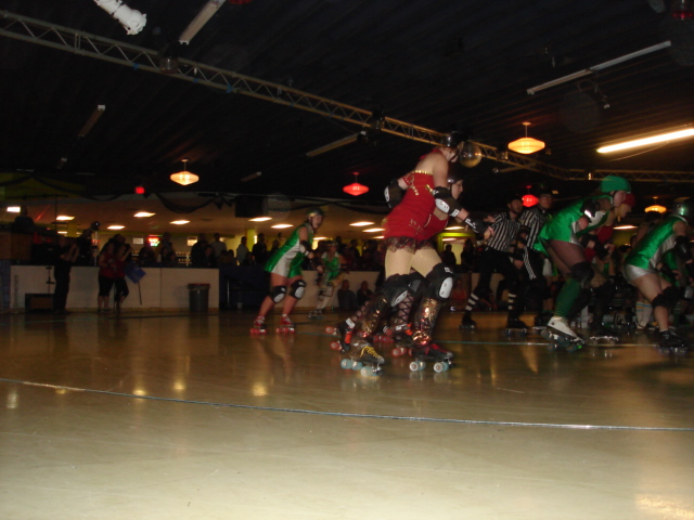 a group of people on skateboards riding around inside