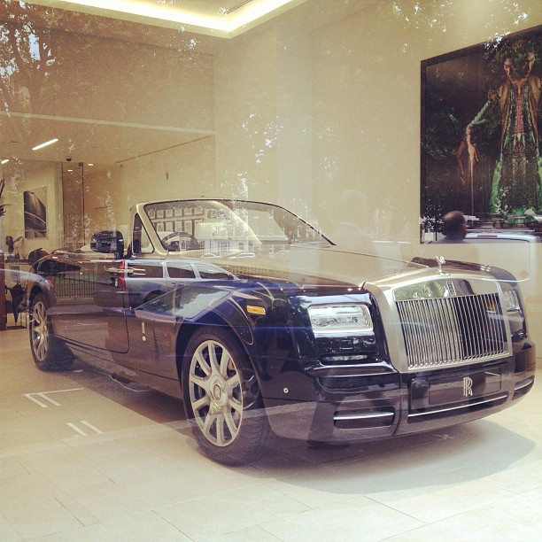an expensive convertible car is displayed in a showroom