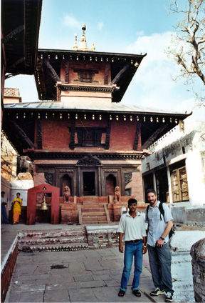 two men standing in front of a large building