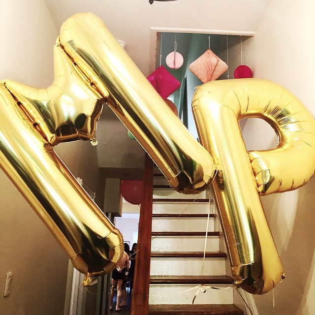 some gold foil balloons and a small staircase