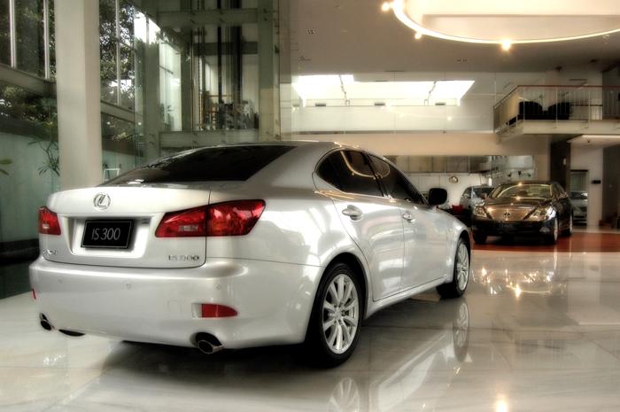 the white car is parked in the building with other cars