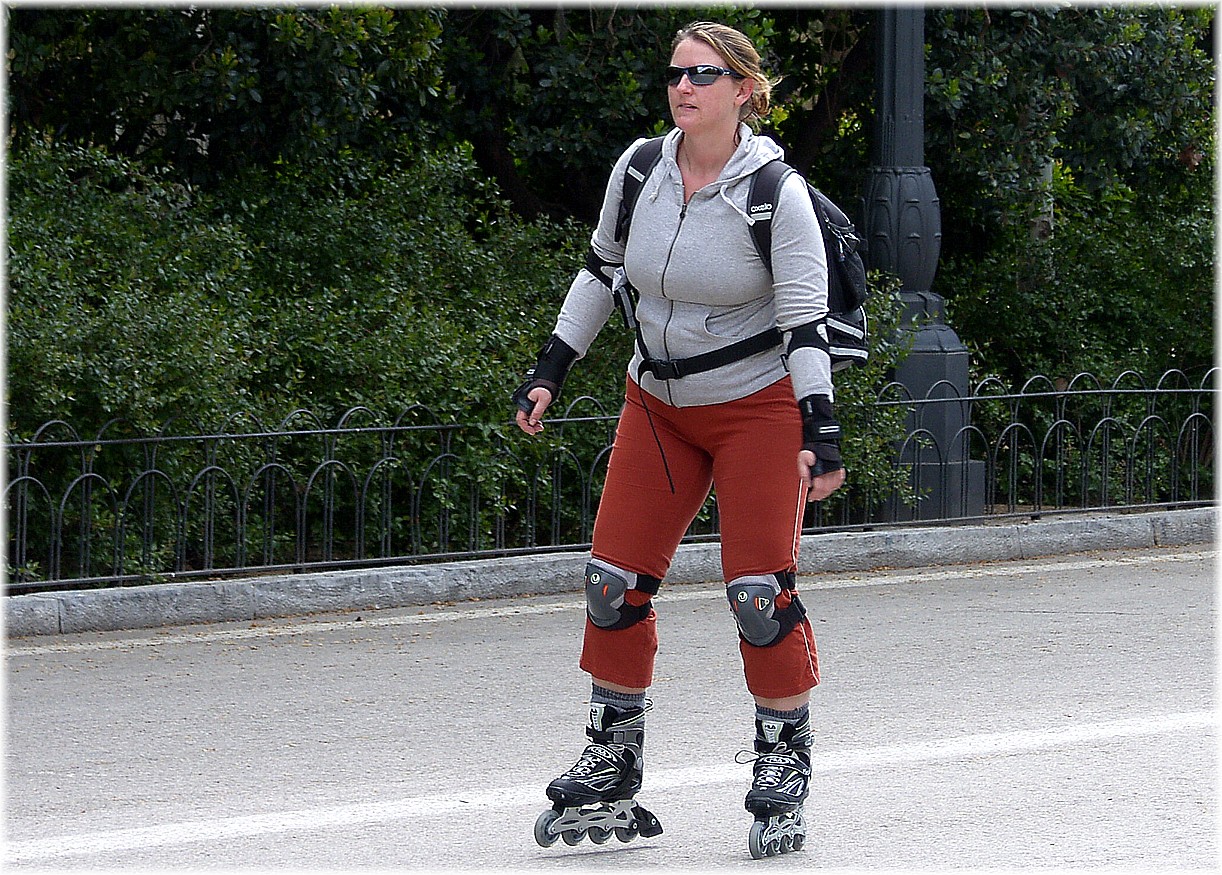 a woman wearing roller skates standing on the street