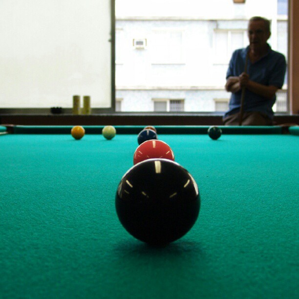 a pool table with two black balls sitting on it