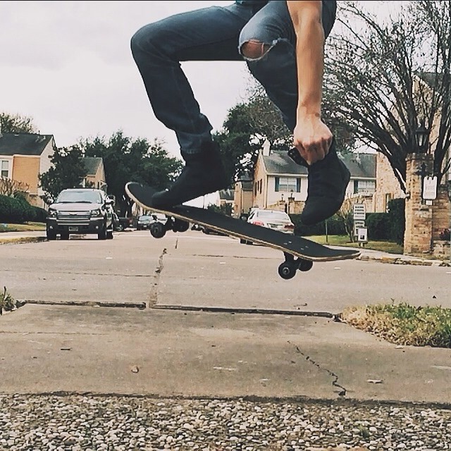 a boy doing tricks on his skateboard outside