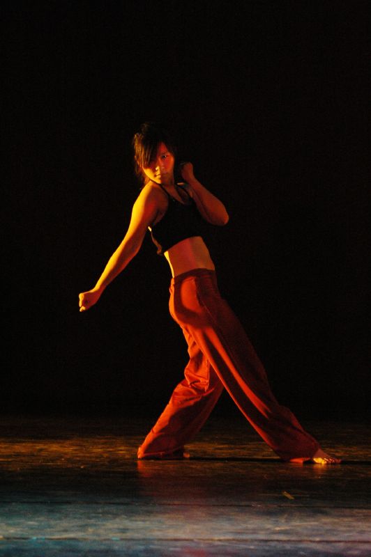 a female dancer in an orange outfit doing a show