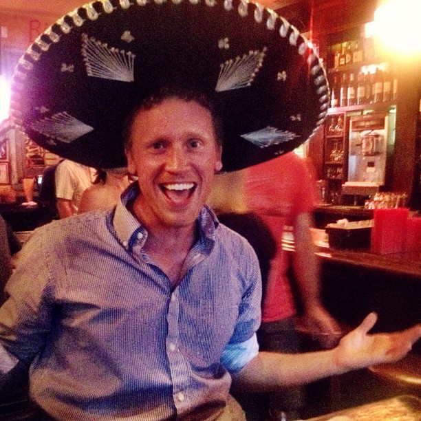 a man wearing a sombrero on his head at a restaurant