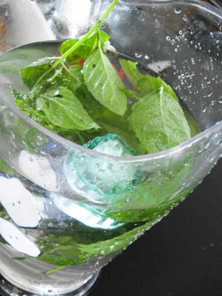 some green leaves in a water filled glass