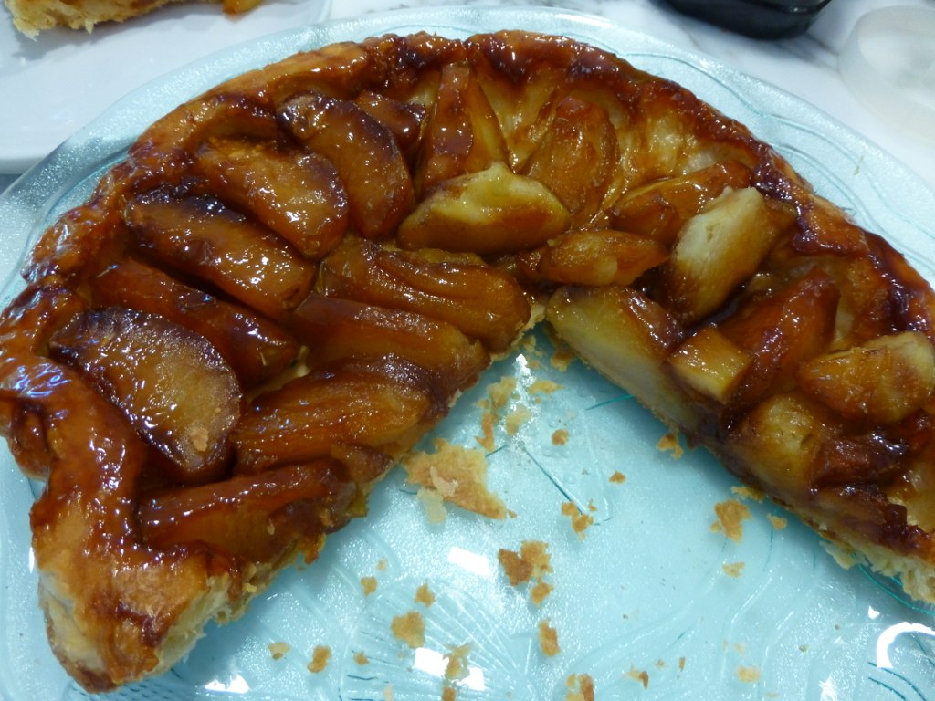 a upside down apple pie with a slice missing