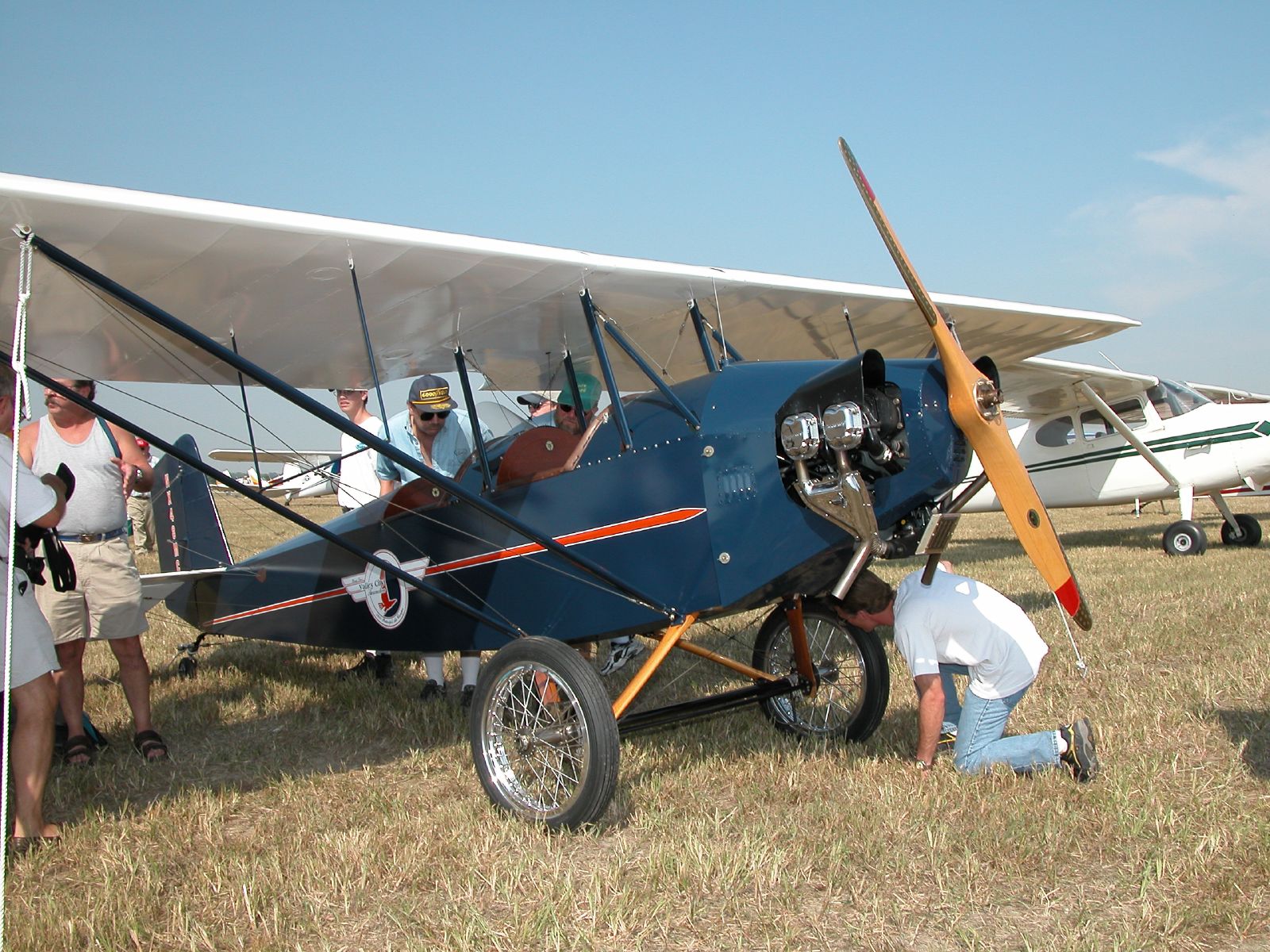 a man putting a small airplane on the ground