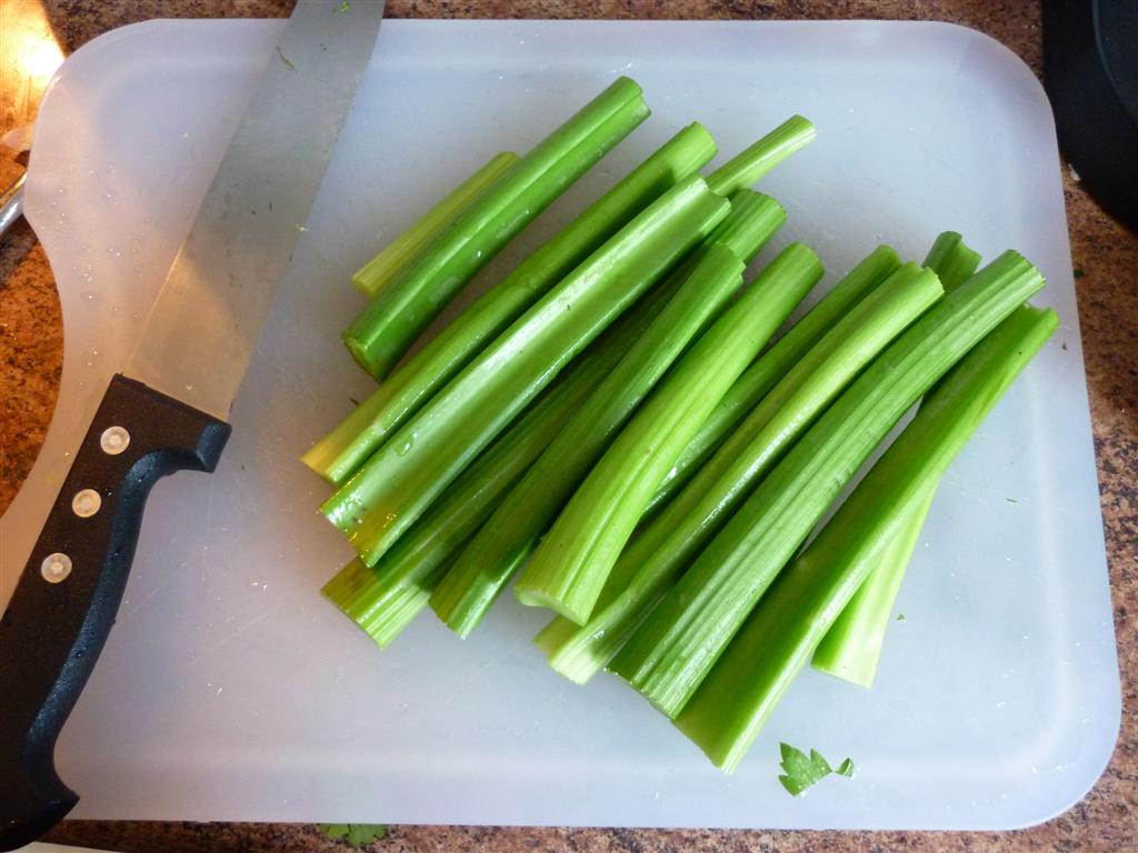 a  board holding celery and a knife