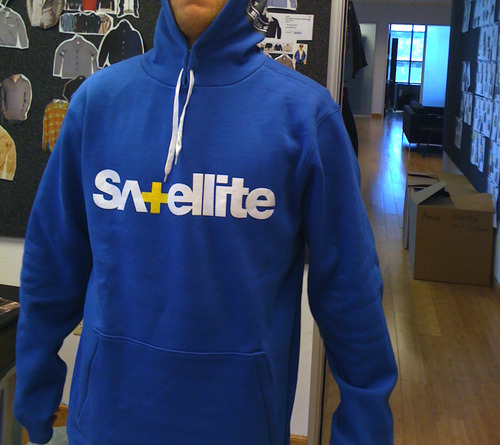 a man wearing a blue satellite sweatshirt looking at the camera