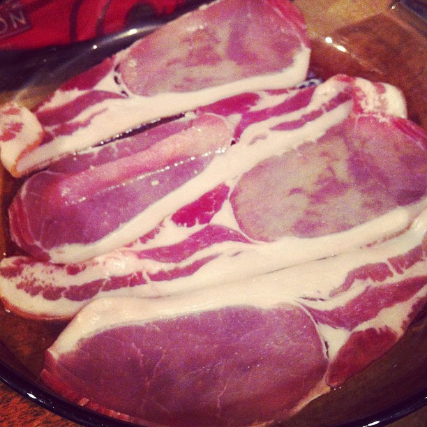 raw bacons and dressing are in a glass bowl