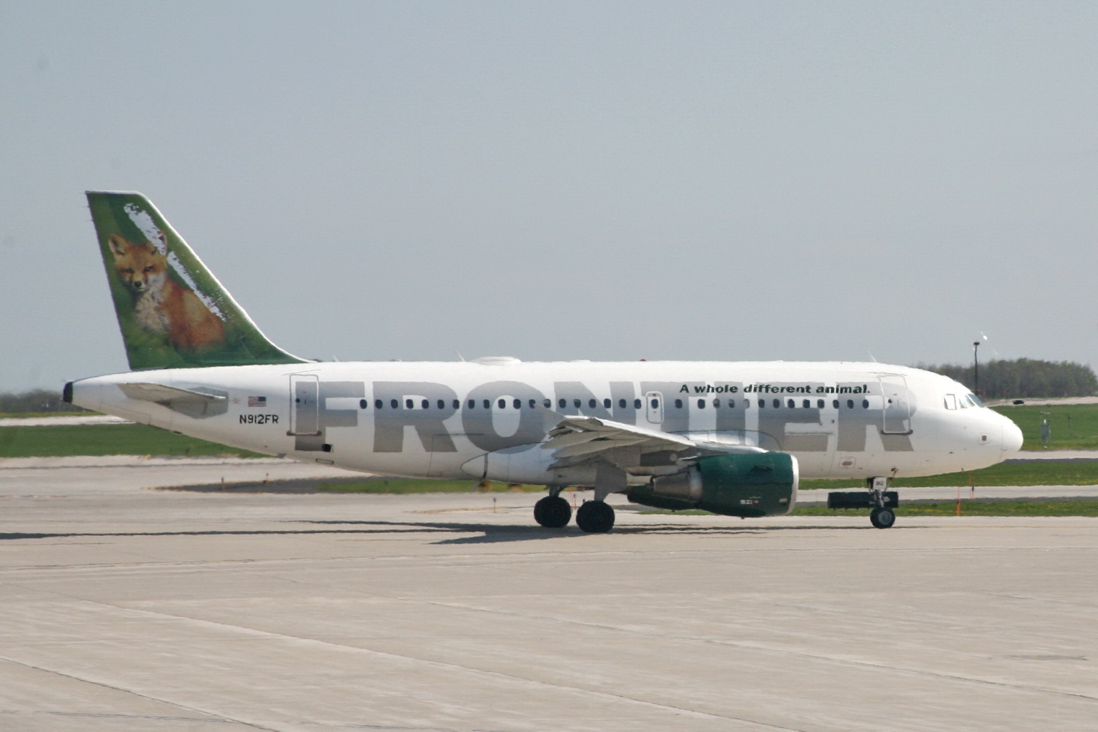 a frontier airline plane is sitting on the runway