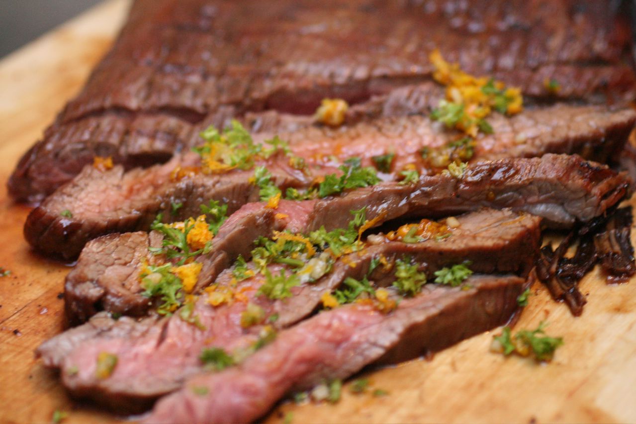 a steak on a wooden chopping board on a table