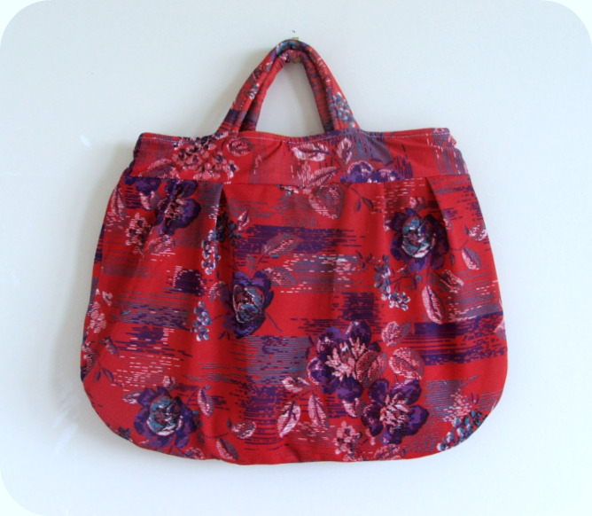 a red purse with pink and purple flowers