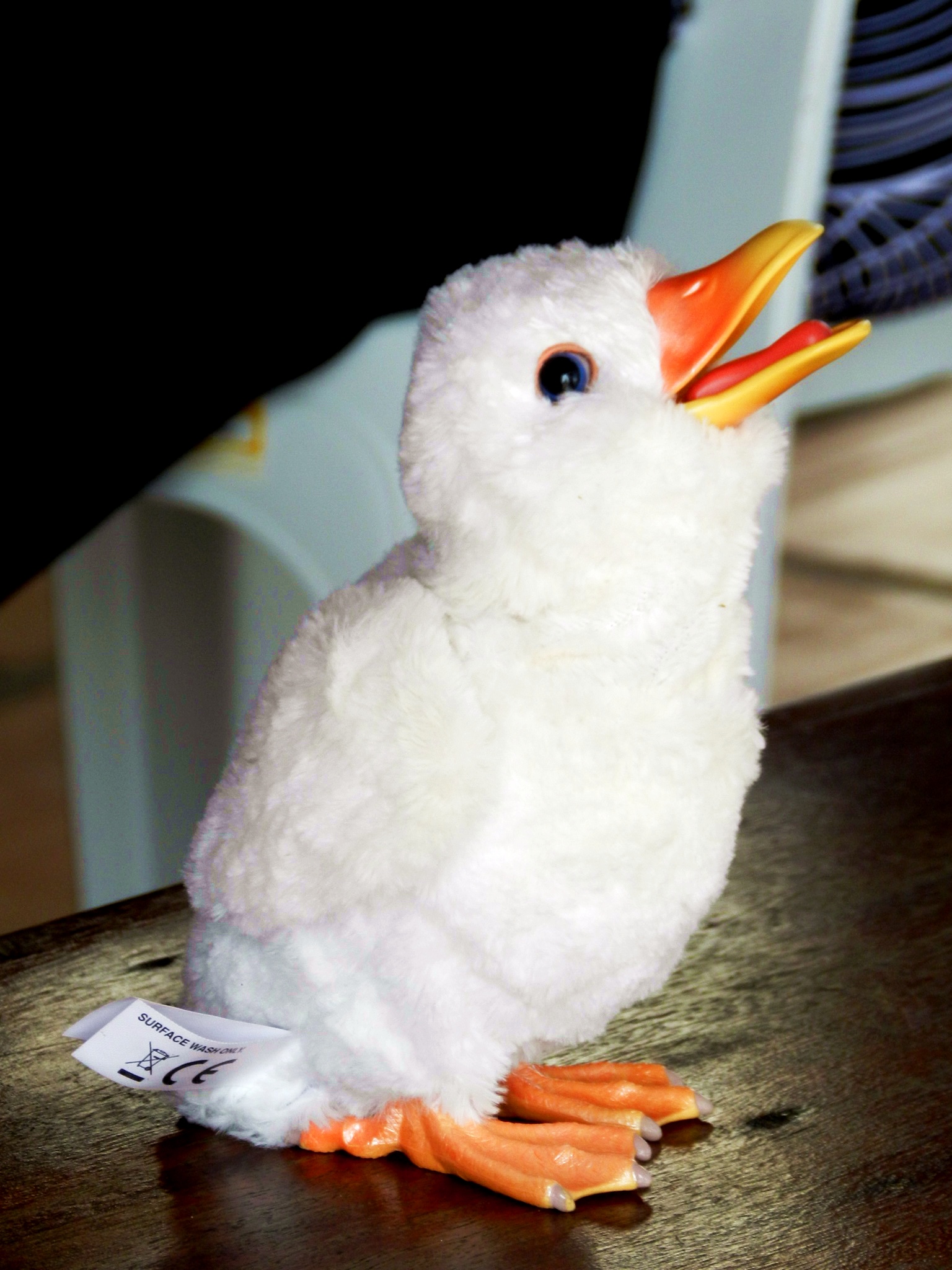 a stuffed toy bird sitting on top of a table