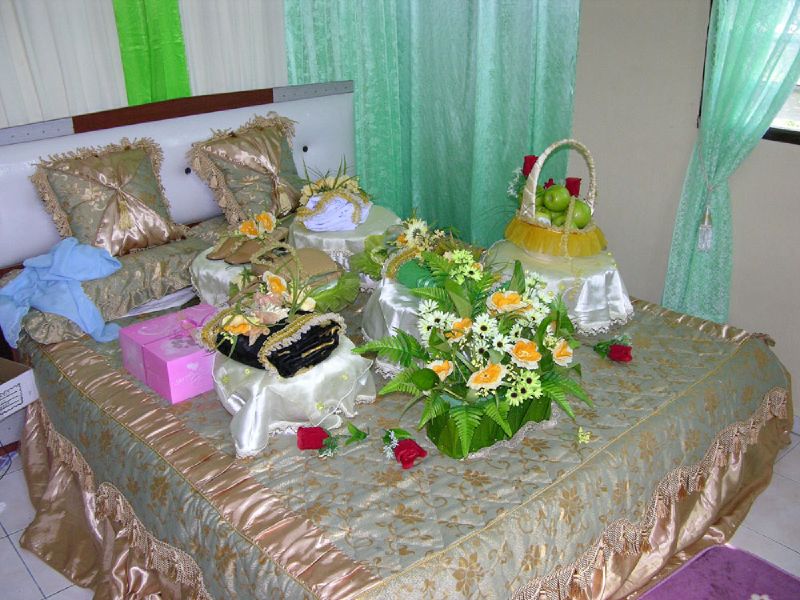 many different types of flowers are on the bed