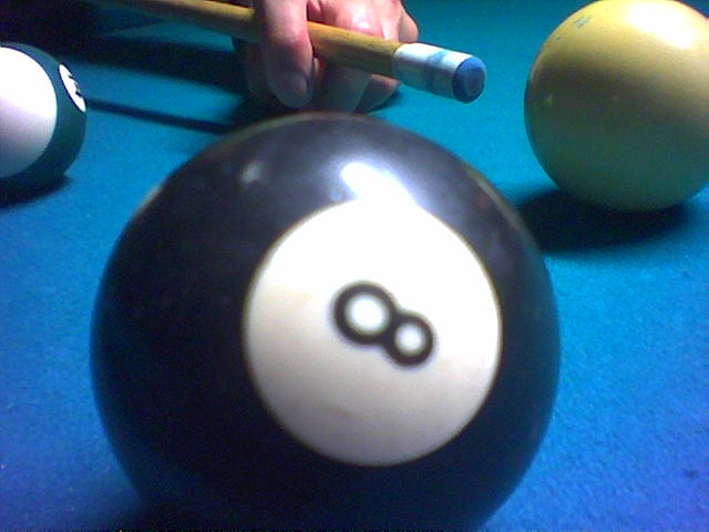 someone holds a pool cue in their hand