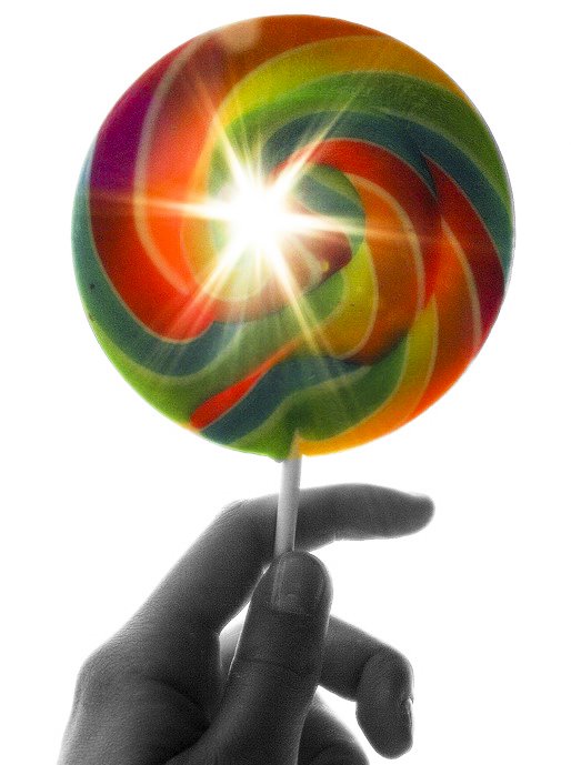 a hand holding a colorful striped lollipop in the air