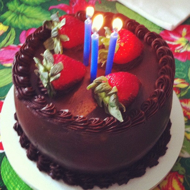 a chocolate cake with chocolate frosting and strawberries