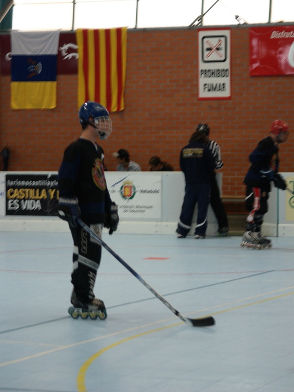 a young person riding on top of a hockey court