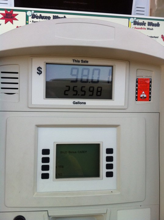 a white gas pump displaying the time of 5 53 pm