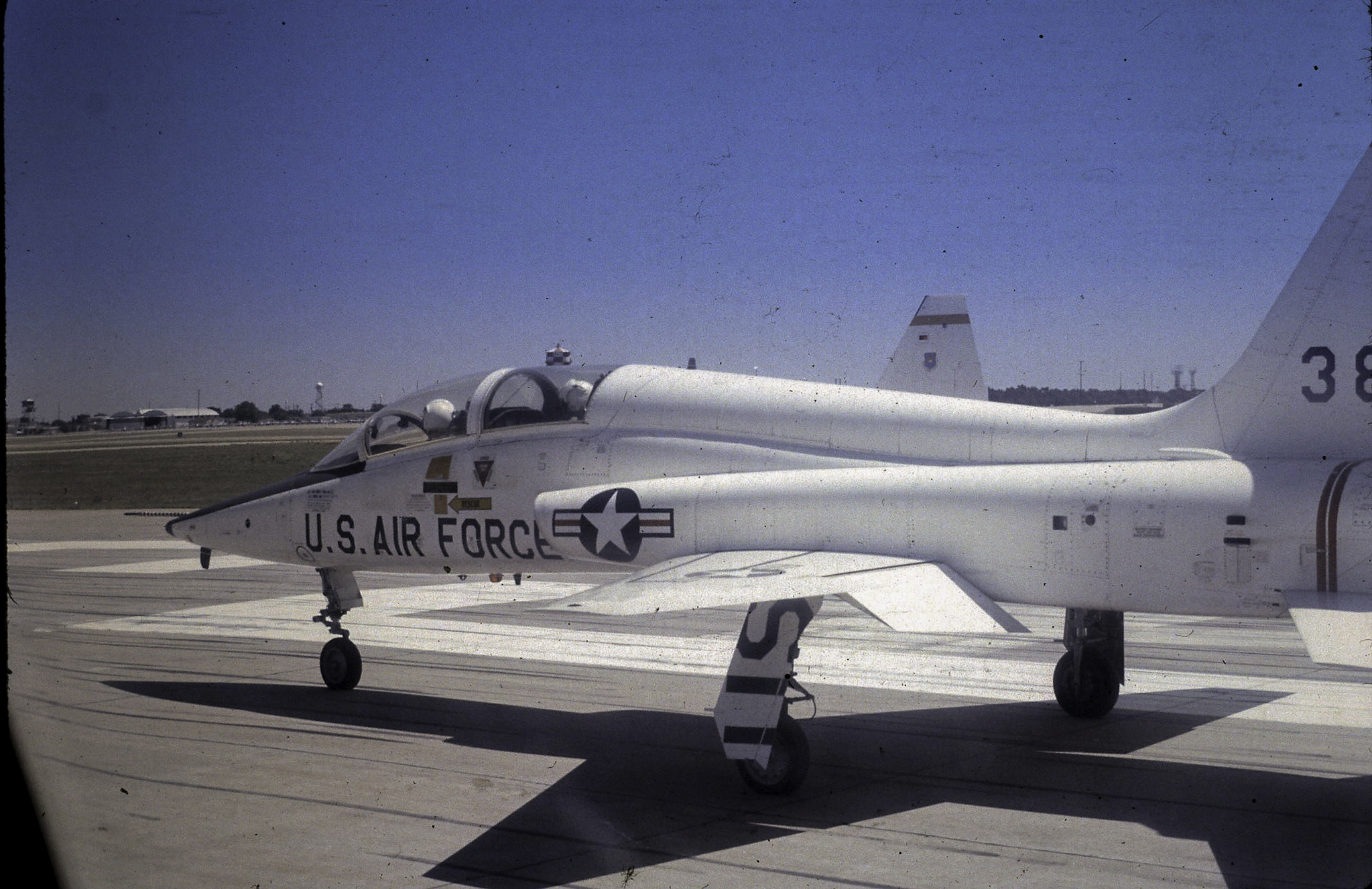 a white fighter jet sitting on top of an airport runway