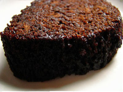a piece of brown cake on a plate