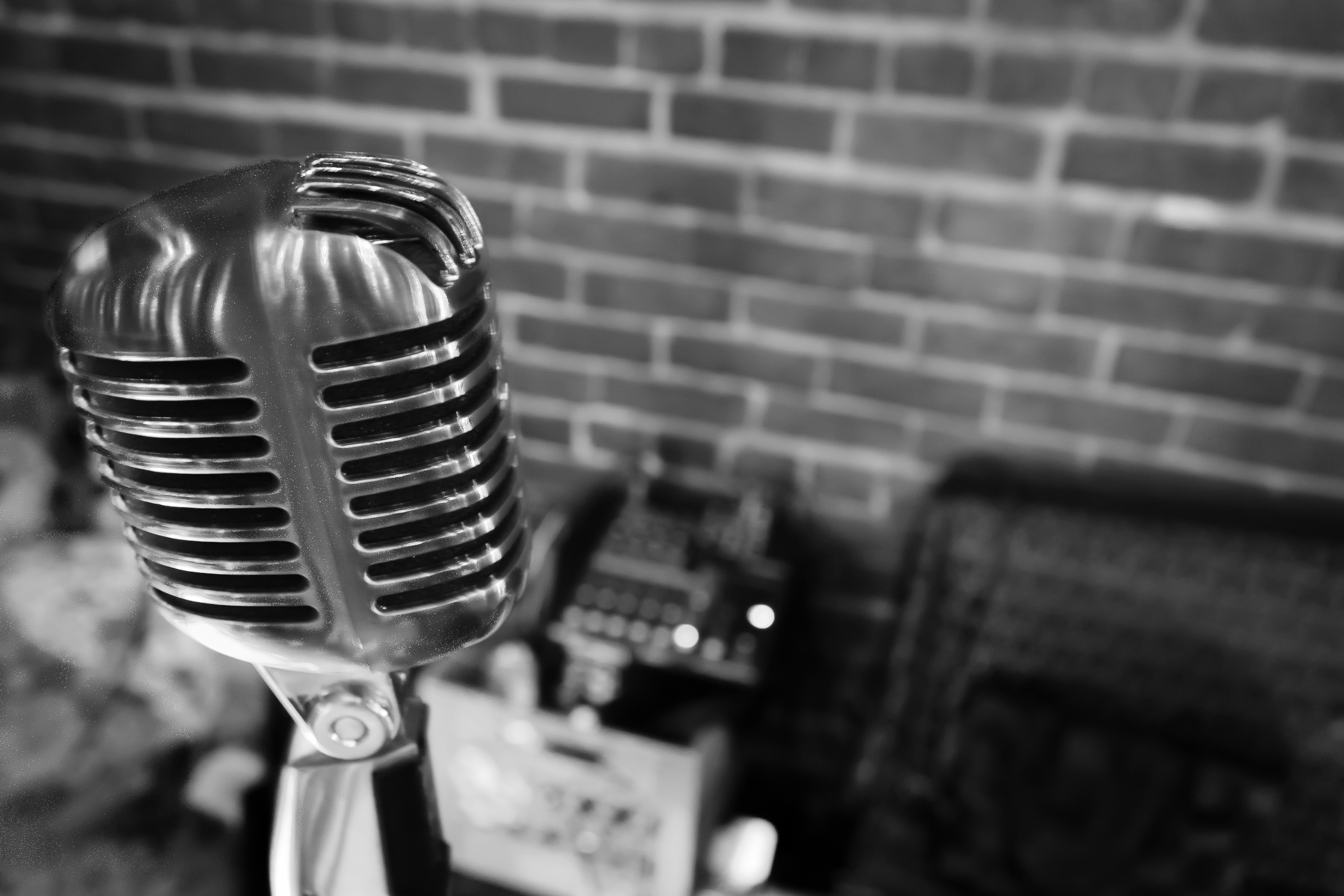 an old fashioned microphone is shown in front of a brick wall