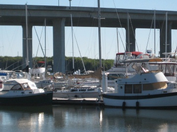 a group of boats docked under a bridge