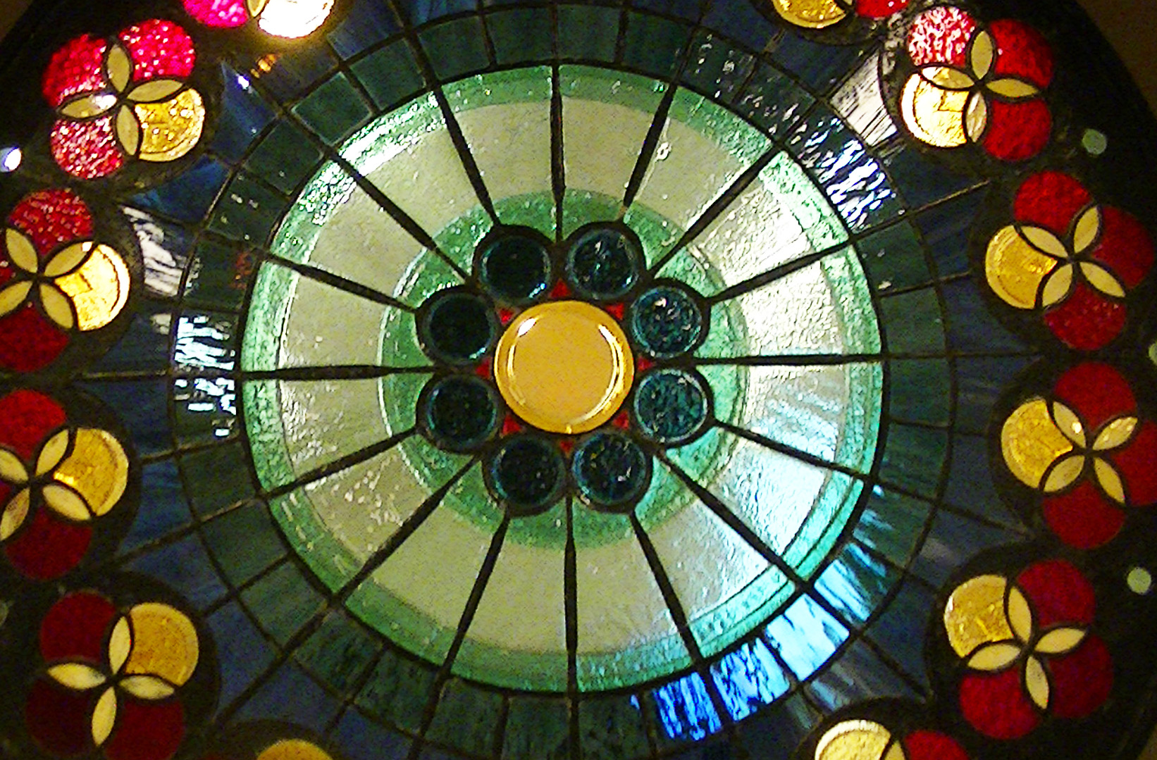 there is a colorful circular glass window with flowers on it