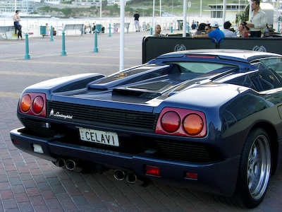 a very pretty and clean sports car parked by the beach