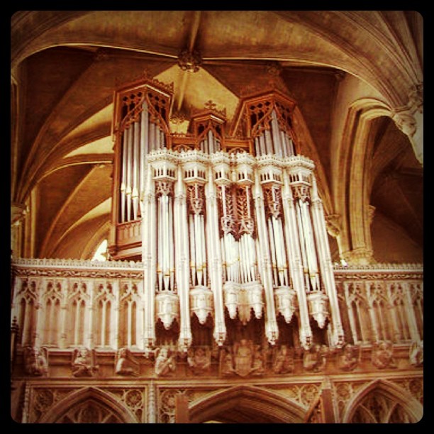 an organ and ornate pillars inside of a building