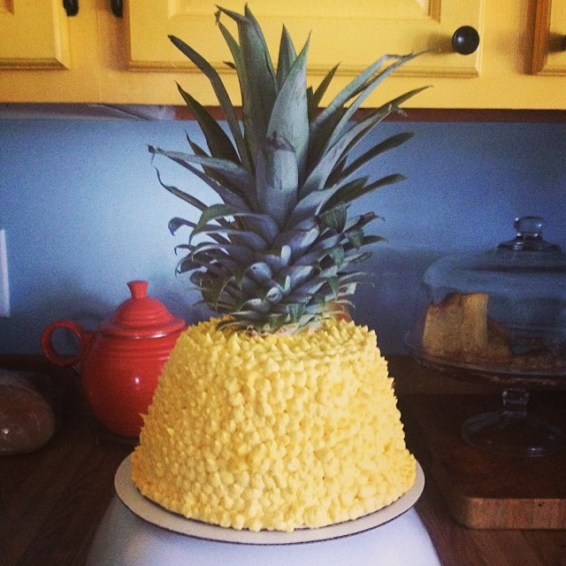 a cake decorated with a pineapple on top