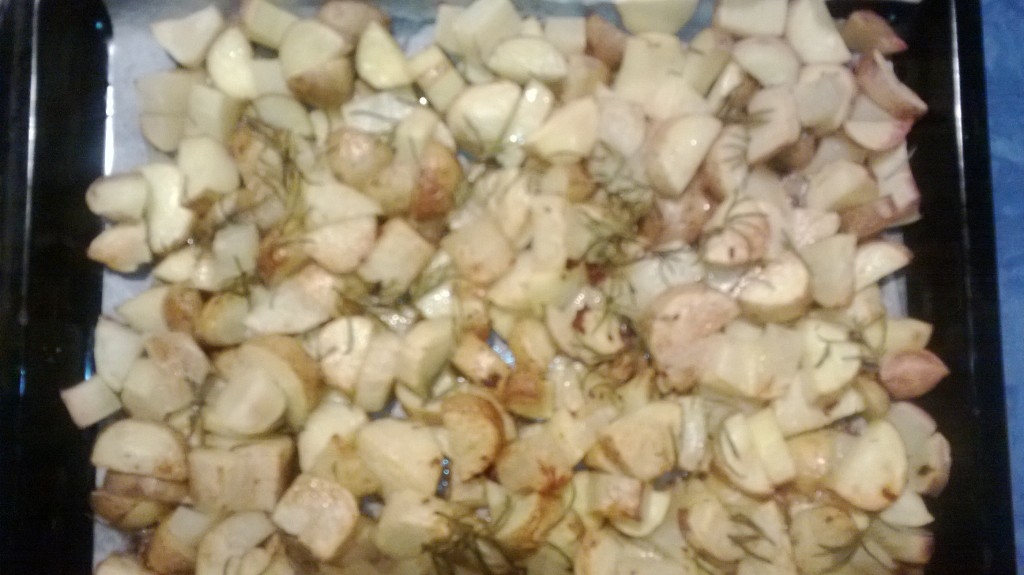 a pan of potatoes and garlic is shown with onions