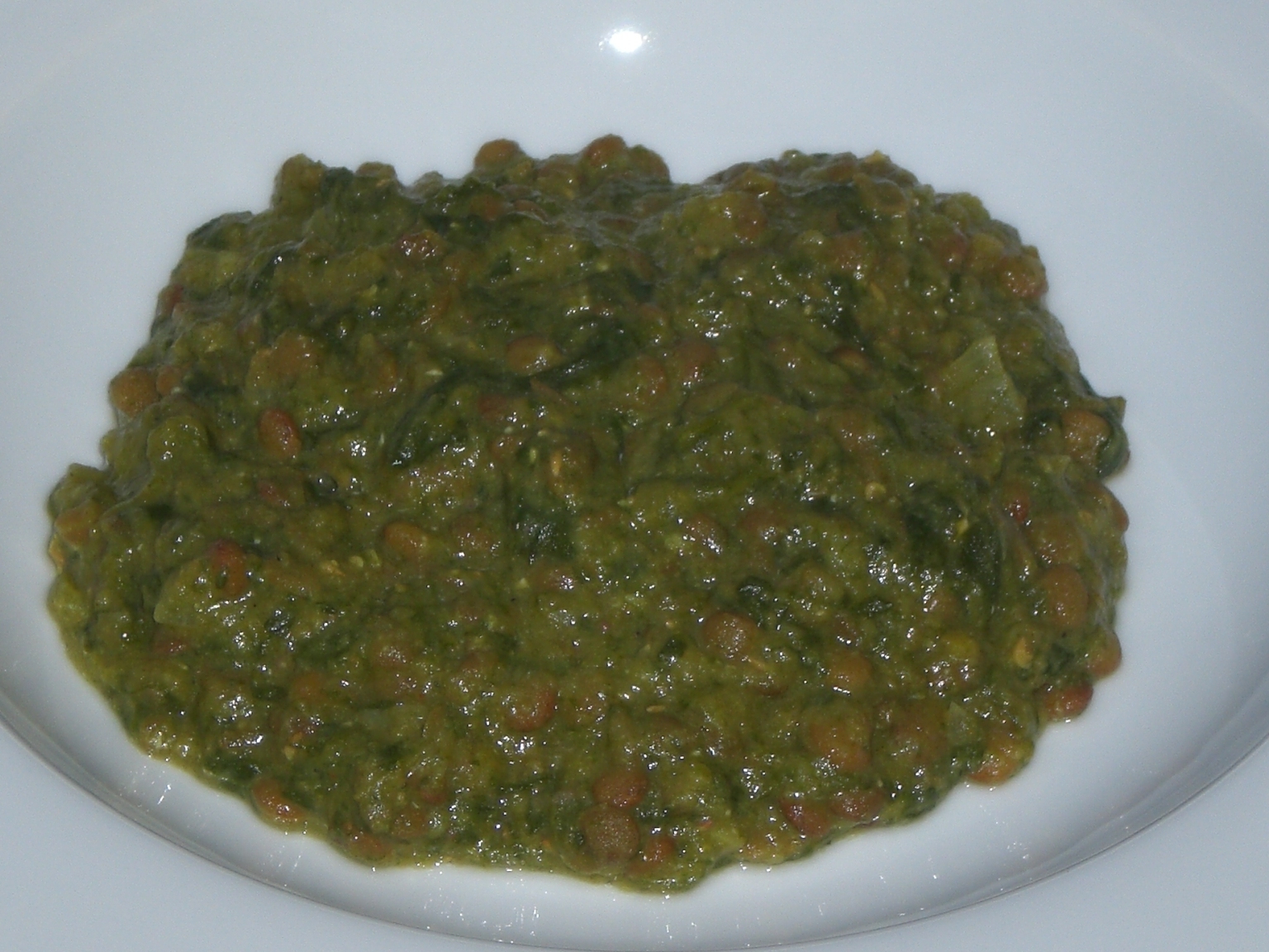 a green salsa in a white bowl