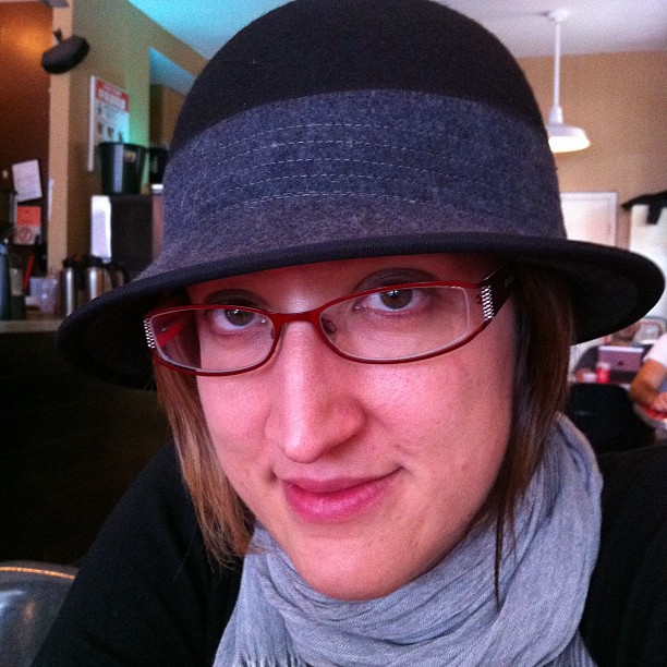 woman with glasses wearing a hat and scarf