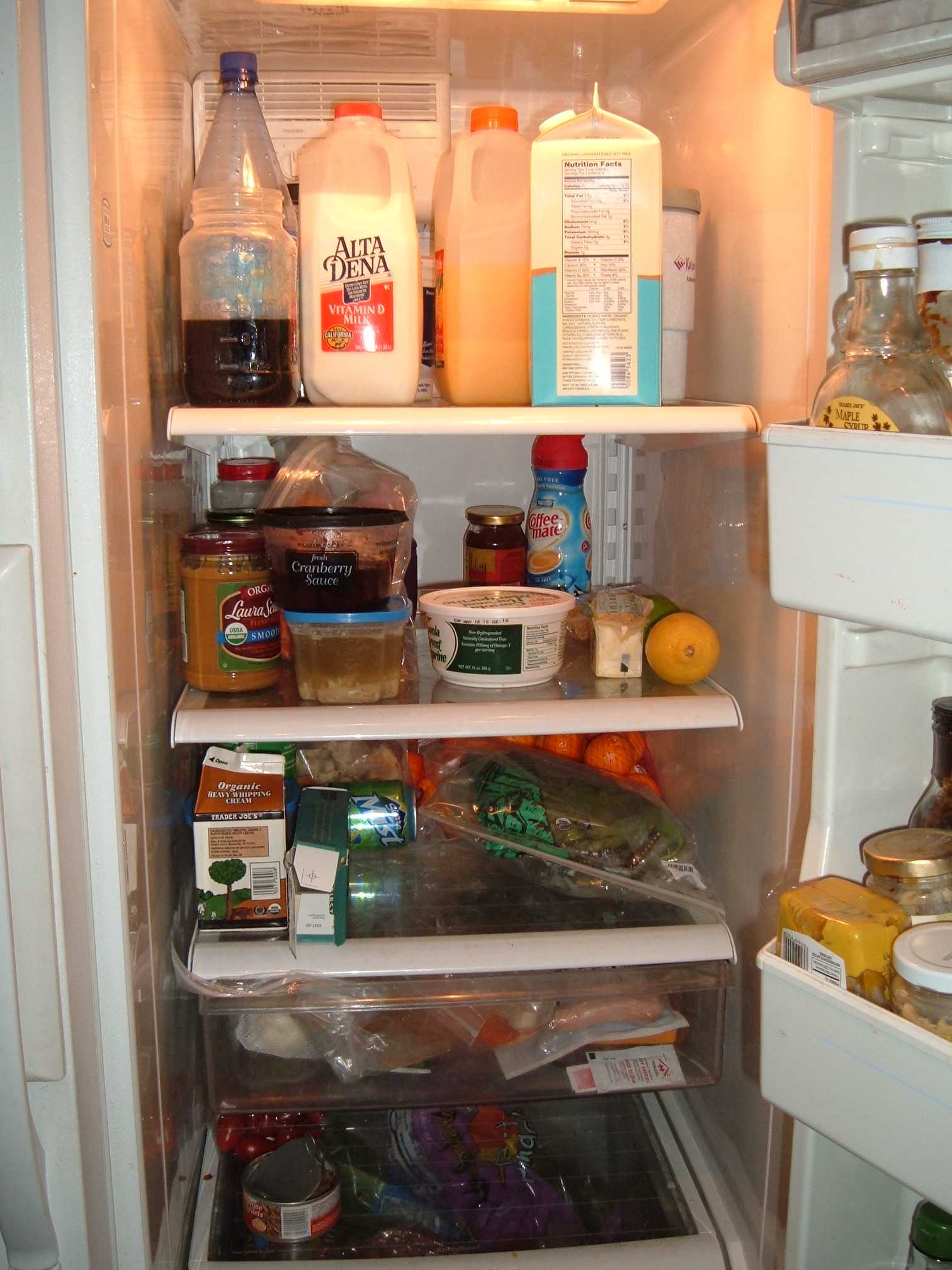 the open refrigerator is filled with all kinds of food