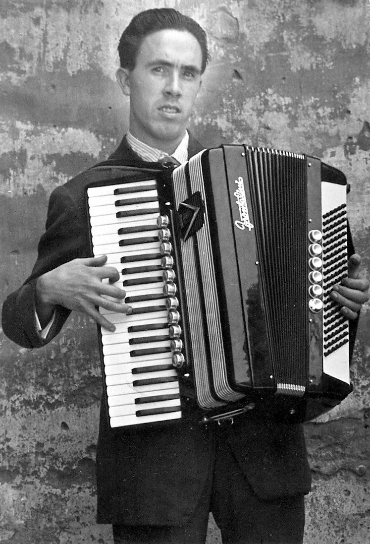 a man in a suit holding an accordion
