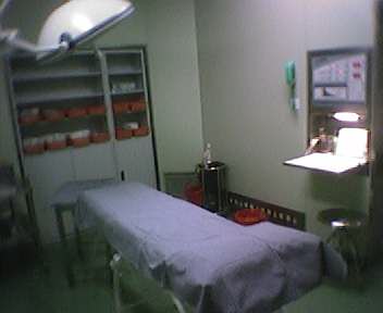 a hospital room with a green floor and green walls