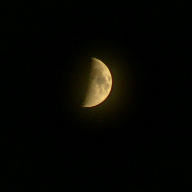 the moon is seen in the dark night sky
