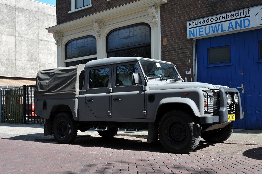 there is a pick up truck in front of a building