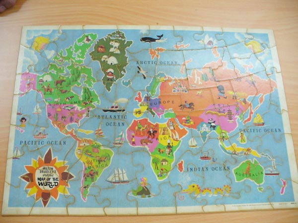 a wooden puzzle of the world map with the countries