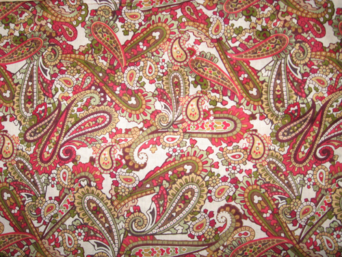 a red paisley print fabric in an unframeled position