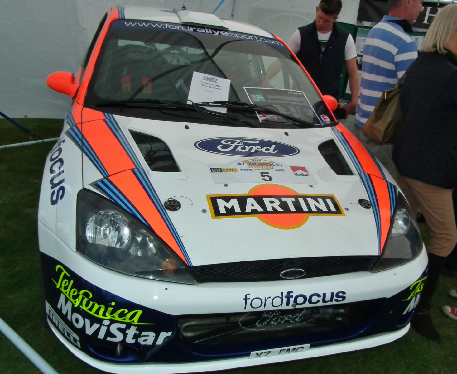 a ford fiesta rally car in front of a tent
