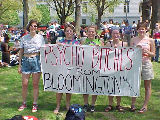 a group of young women holding up a banner