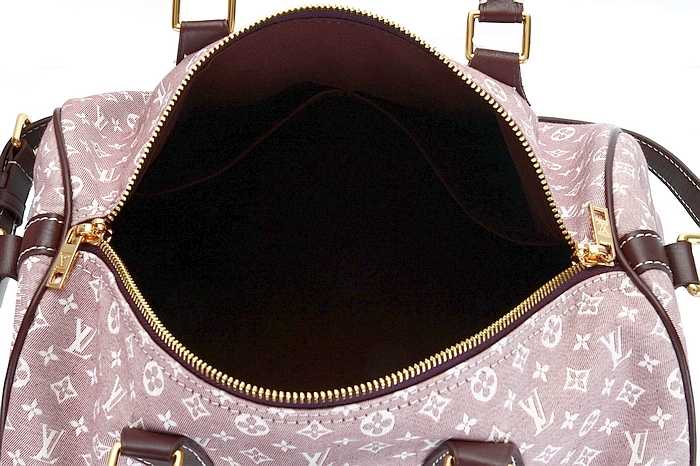 a pink handbag with a small gold zipper