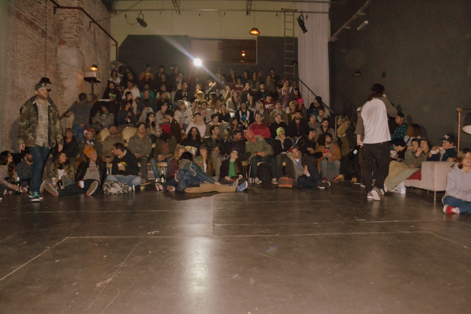 there are lots of people sitting in an auditorium watching a man on stage