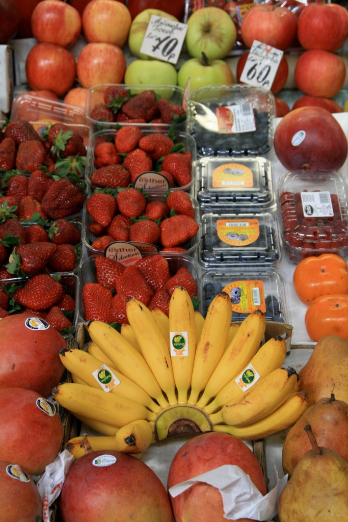 a variety of fruits are on display in a grocery store