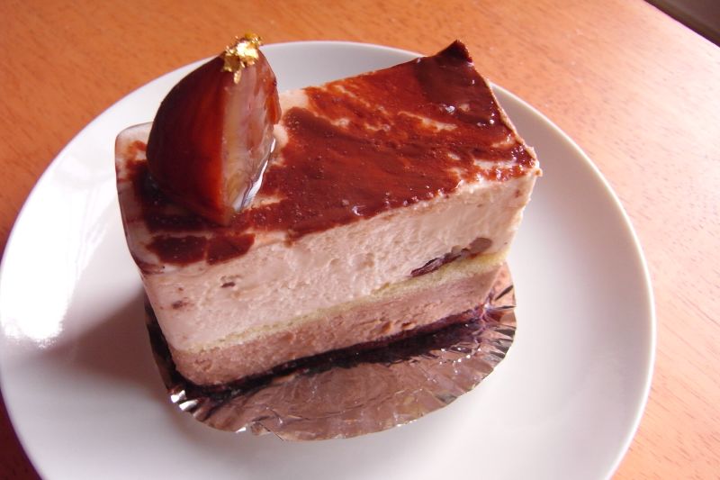 a piece of chocolate cheesecake with a cherry topping on top